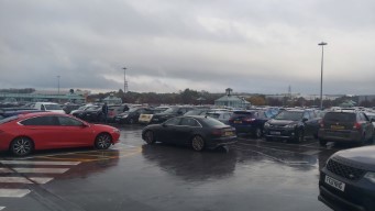 A large, wet, busy car park.