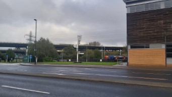 A sign, a tram, and the double-decker motorway viaduct.