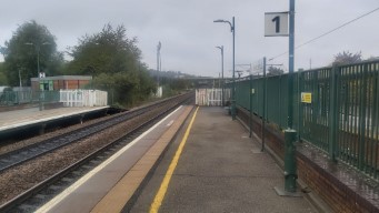 The train platform. A tram is in the background